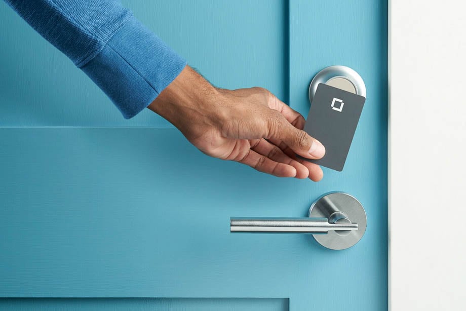 Photo of a blue door, stainless steel handle and a room key card taken by San Francisco-based product photographer Ian Hanson. 