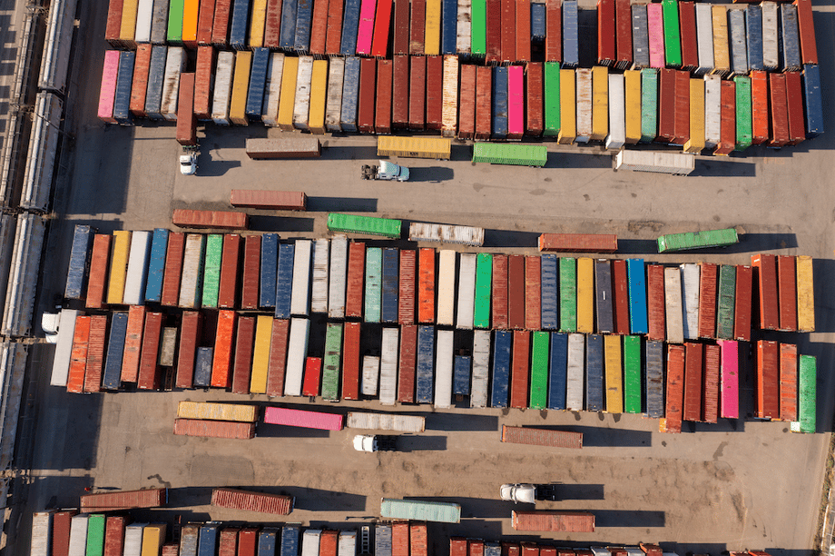 Aerial drone shot of colorful shipping containers in paved lot, by San Diego-based industrial photographer Frank Rogozienski.