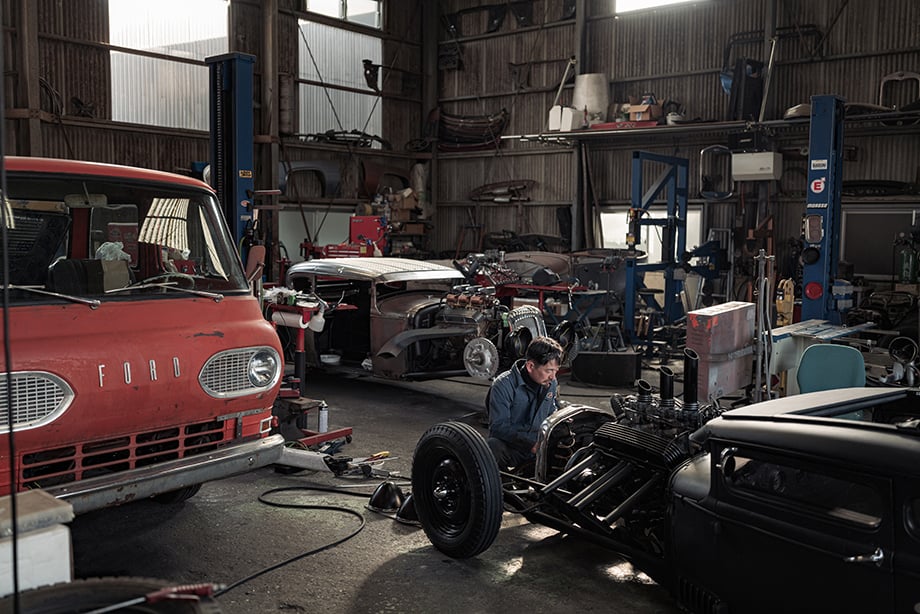 Man working on automobile shot by Irwin Wong for his book Obsessed.