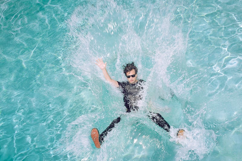 Man jumping into pool by Jon Stars