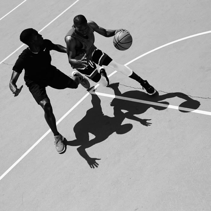 Black and white photo of two basketballers playing on the court taken by London-based sports photographer Jacob Sutton. 