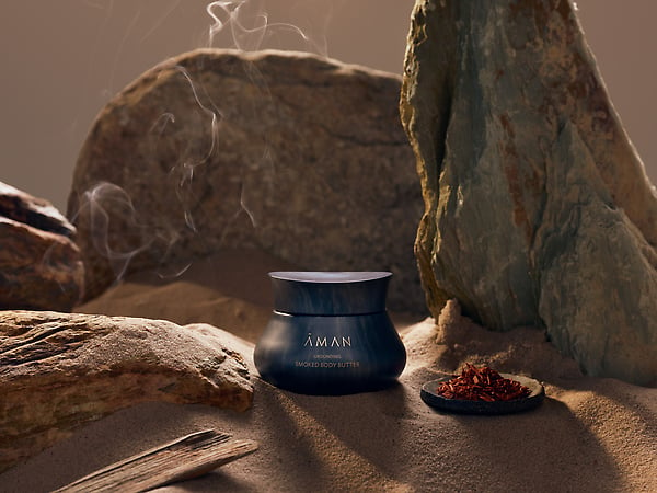 Desert-scape still life of smoked body butter with sand, rocks, and smoke, by London product photographer Jake Curtis.
