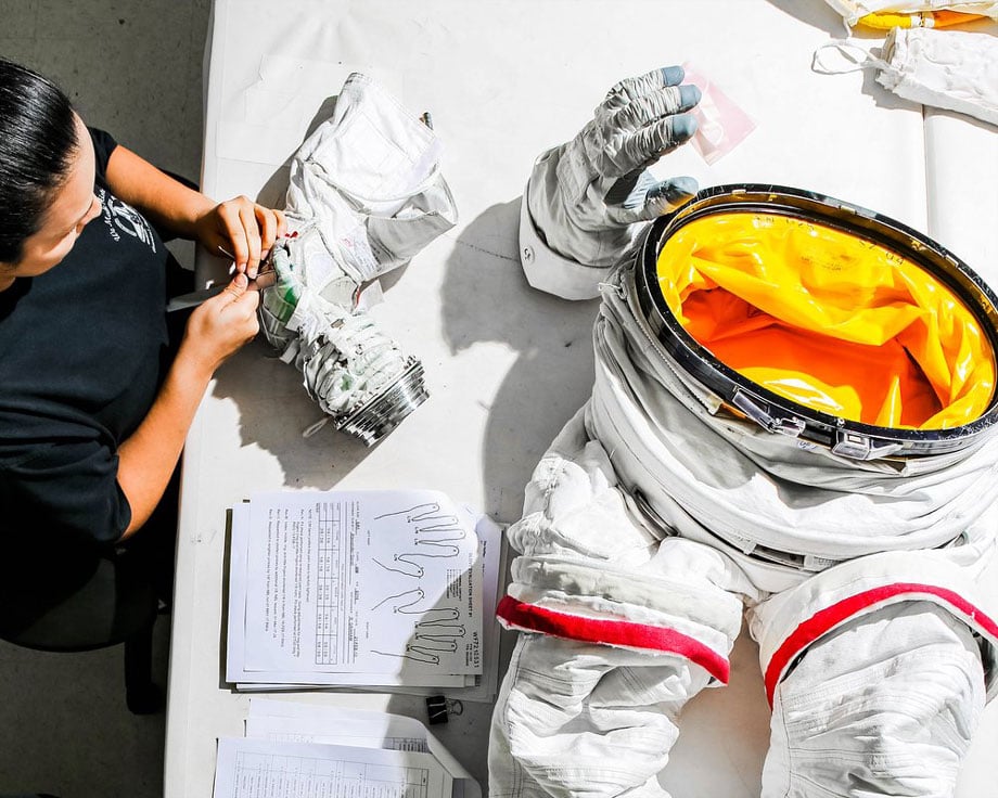 A woman knitting together a spacesuit at NASA taken by New York-based industrial photographer Jayme Thornton. 