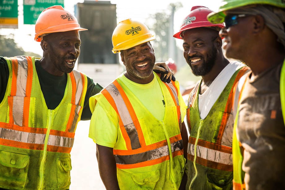 Photo of a group of African American construction workers having a laugh taken by Los Angeles-based industrial photographer John Davis.