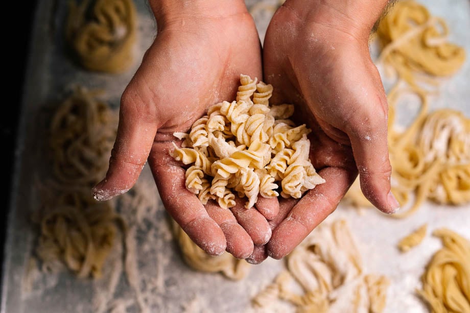Photo of a chef's hands holding pasta taken by Los Angeles-based food photographer Jonathan Young