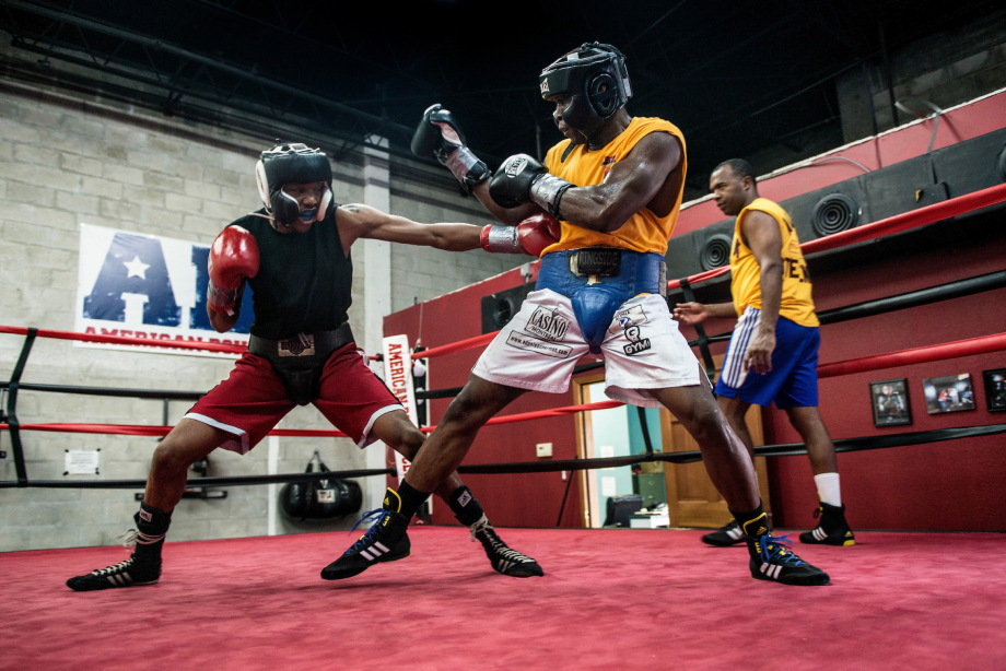 Photo of two men practice sparring at a gym taken by Miami-based sports photographer Josh Ritchie. 