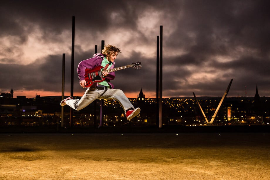 Final image of a guitarist jumping with the city of Derry in the background, captured by Rob Durston.