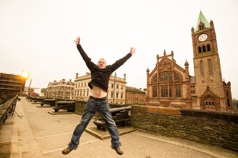 Colin Tuff, assistant to portrait photographer Rob Durston, jumps in the air in a starfish-like pose.