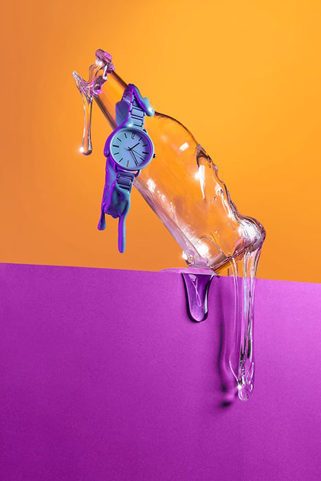 Photo of glass bottle and watch dripping with slime to give melting effect.