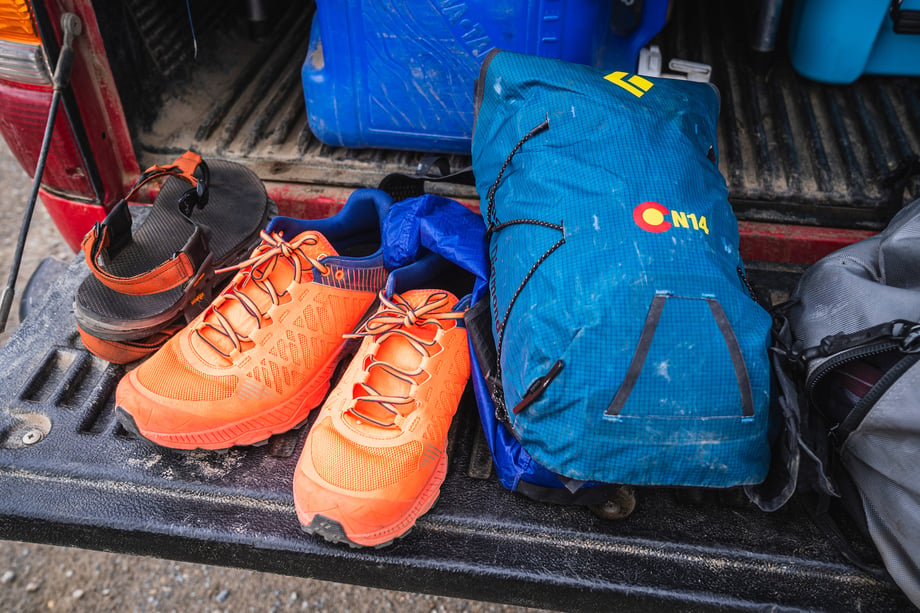 Louis Arevalo captured a still of Joe Grant's gear in his truck bed: a small daypack, orange trail runners, and sandals
