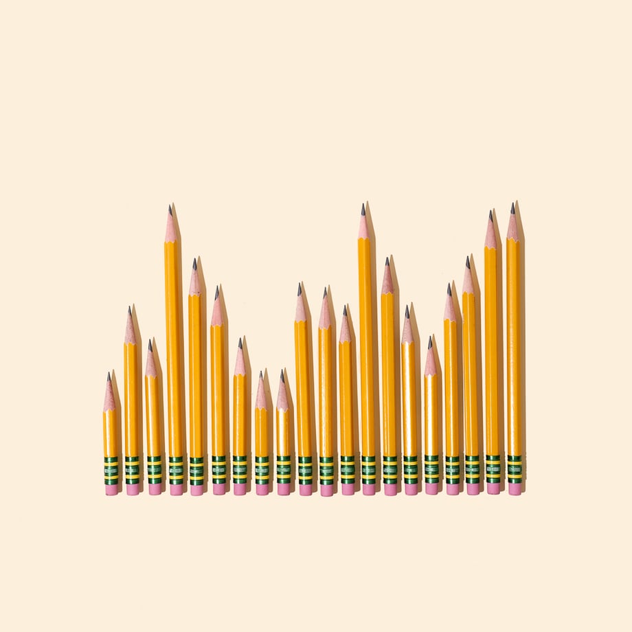 Conceptual photo of various sized yellow sharpened pencils depicting a bar graph. 