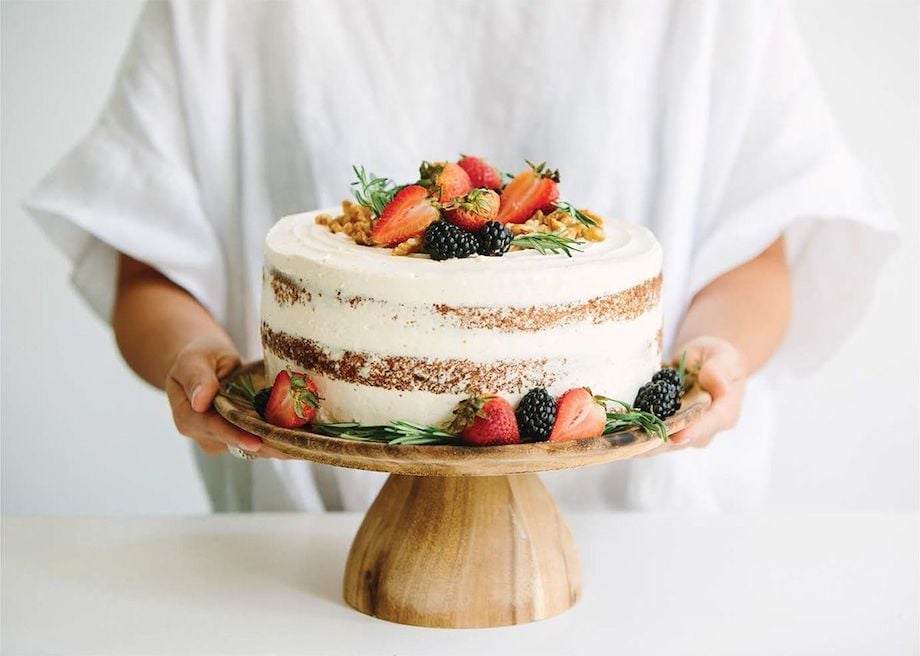Portait of layer cake on stand with nuts and berries, by Singapore food photographer Lauryn Ishak.