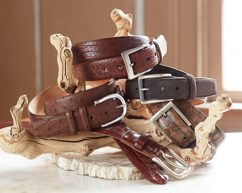 Photo of various leather belts wrapped around a dried wood sculpture taken by Atlanta-based product photographer Leah Perry.