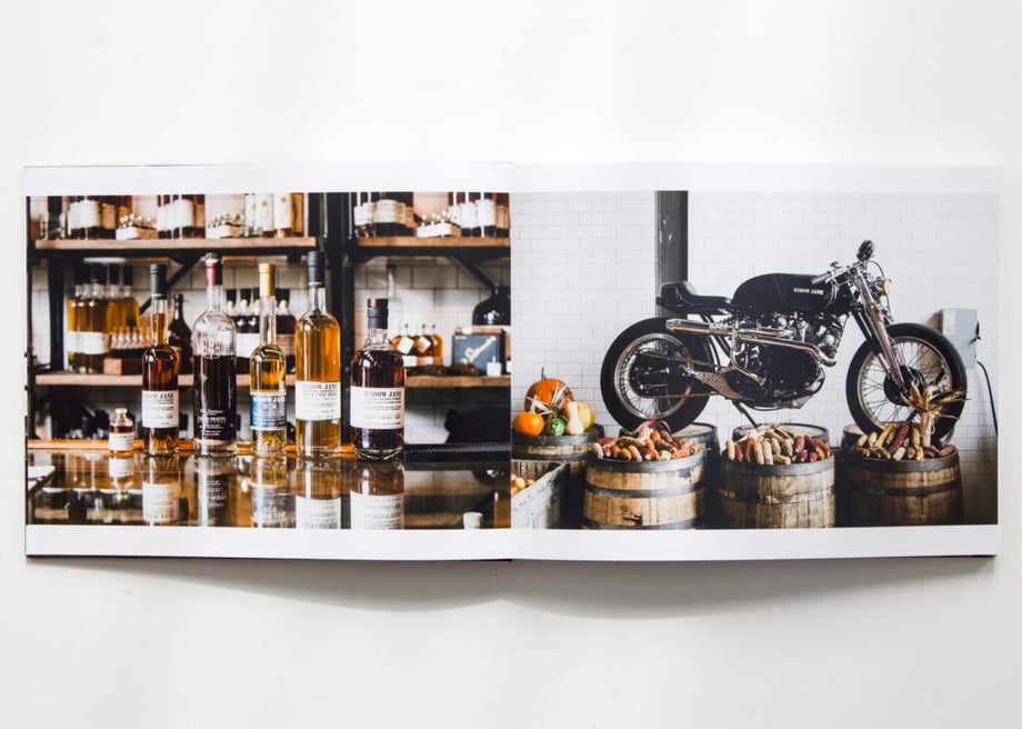 Adam Lerner's new print portfolio open to images of whiskey and a motorcycle.