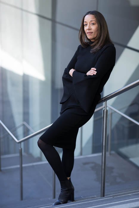 Photo of a businesswoman leaning against a staircase rail taken by Los Angeles-based corporate photographer Margo Moritz. 