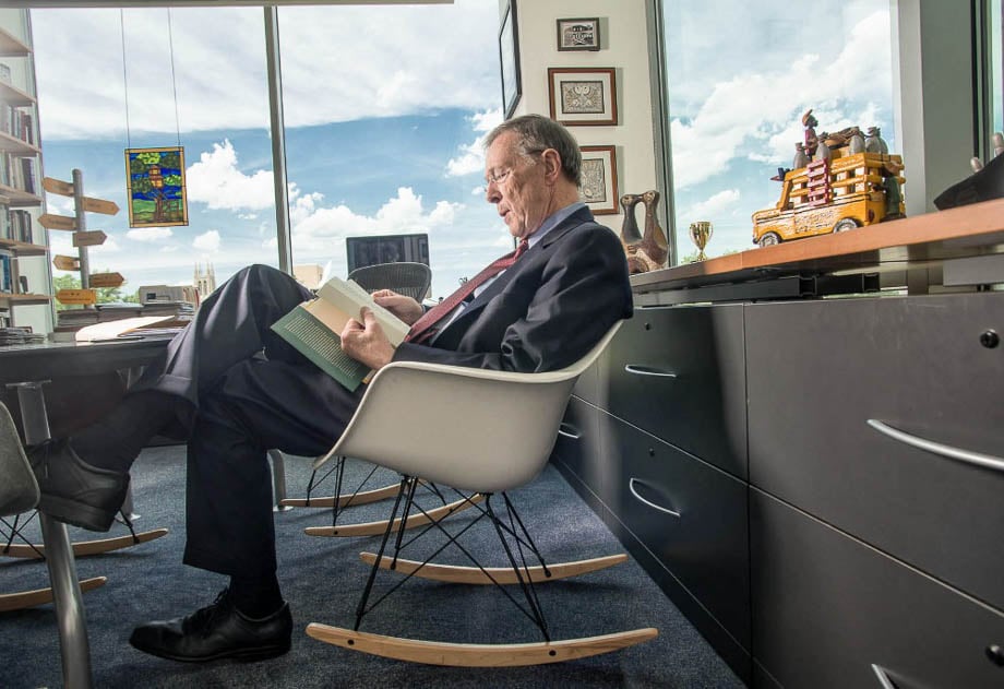 A businessman reading a book in his office taken by Chicago-based corporate photographer Matthew Gilson. 
