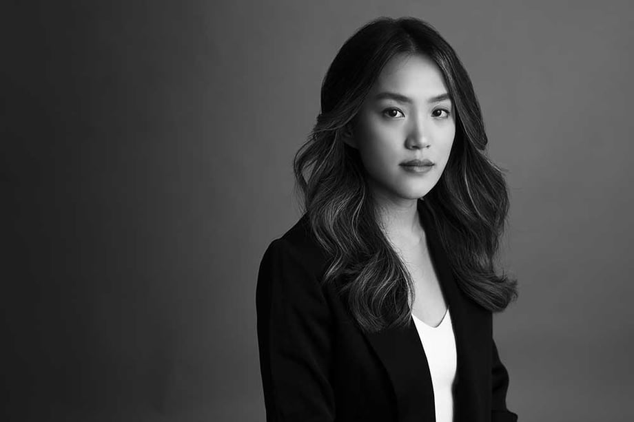 Black and white portrait photo by Melody Ling of a woman in smart business attire.