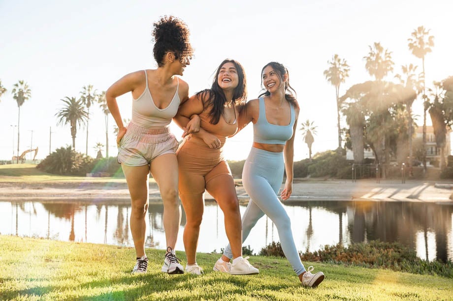 Photo of three female friends in activewear outdoors taken by Los Angeles-based lifestyle photographer Michelle McSwain.