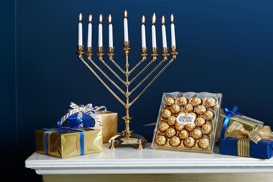 Hanukkah display with gifts, menorah, and box of Ferrero Roche.  