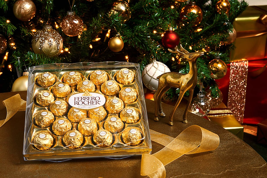 Box of Ferrero Rocher in front of Christmas tree.