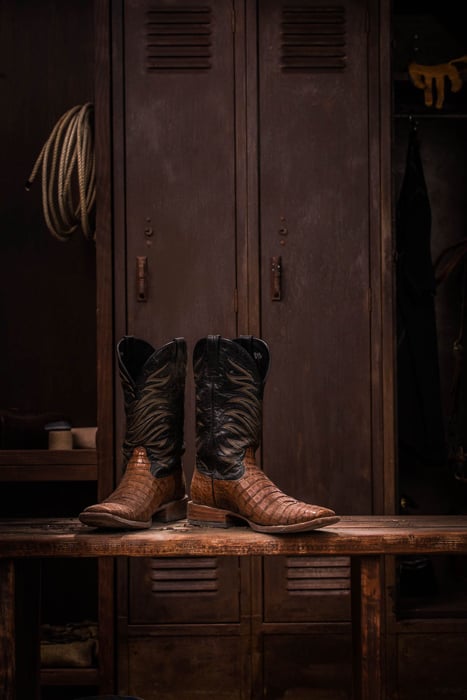 Photo of brown leather boots resting on a bench taken by New York-based product photographer Nick Kova. 