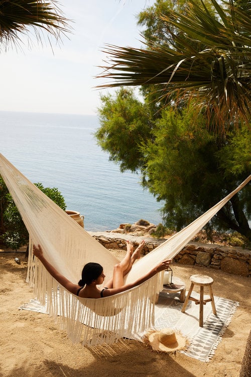 Photo by Nicole Franzen of a woman sunbathing in a hammock.