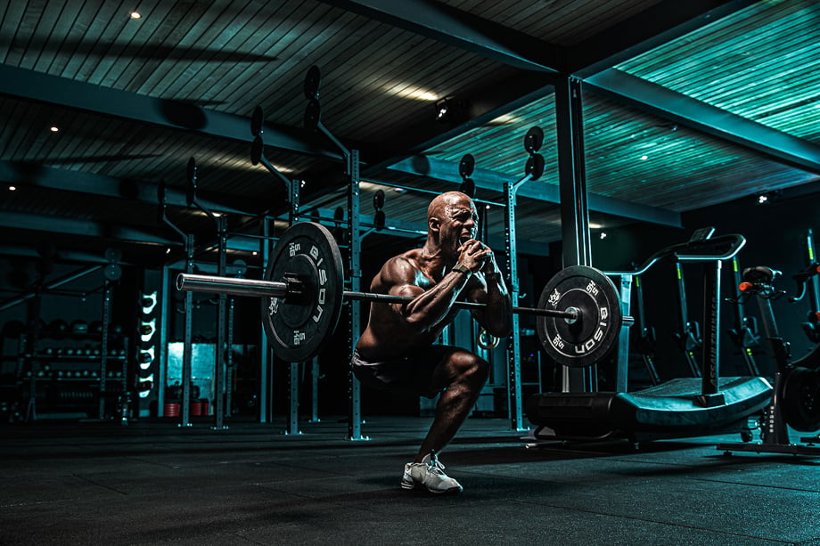Photo of Tyler Saunders doing a squat in the gym taken by London-based sports and fitness photographer Pete Muller. 