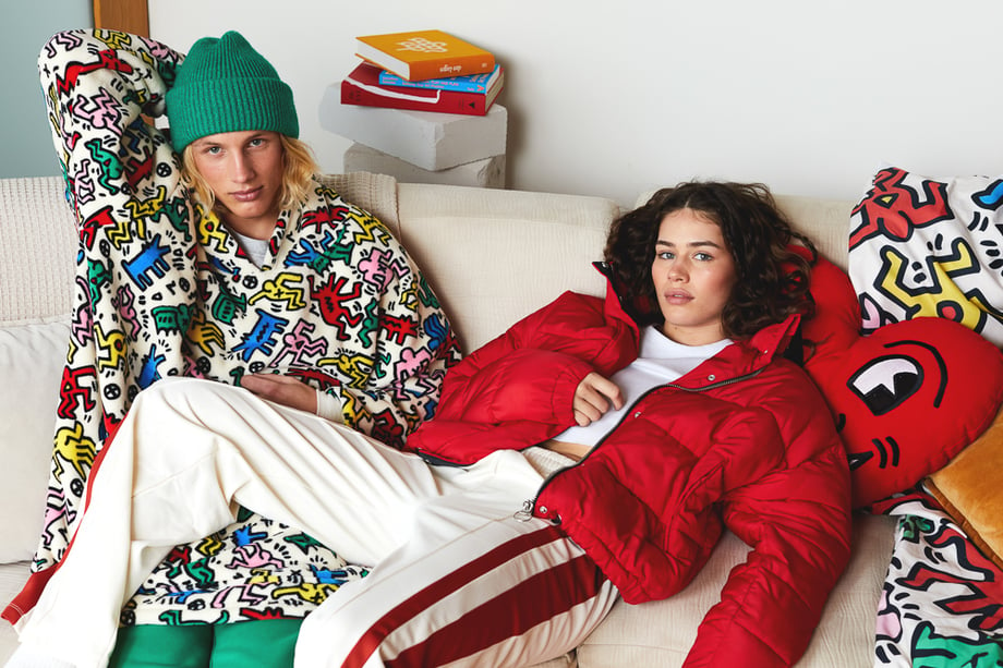 A man and woman in a living room wearing winter clothes featuring Keith  Haring's artwork for Typo.