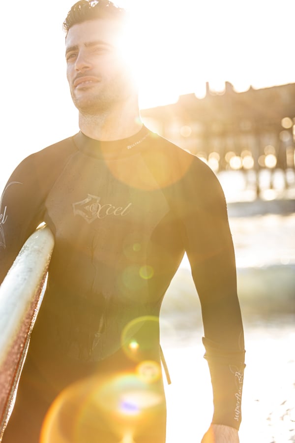 A surfer walking on the beach, board in hand, by photgrapher Randy Korwin of Blue Island, Illinois 