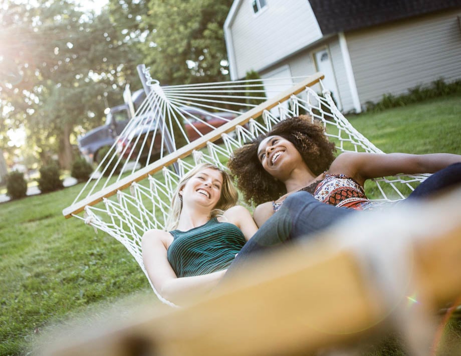 Photo of two female friends relaxing on a hammock outside taken by Chicago-based lifestyle photographer Randy Michael Korwin. 