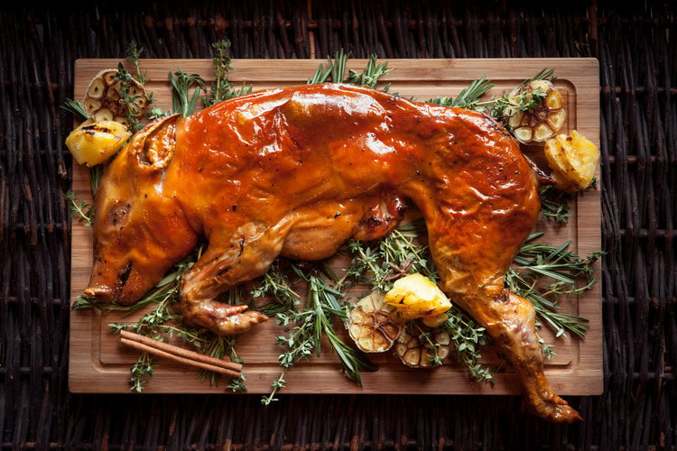 Aerial of roasted pig with garlic and herbs, by Singapore food photographer Rory Daniel.
