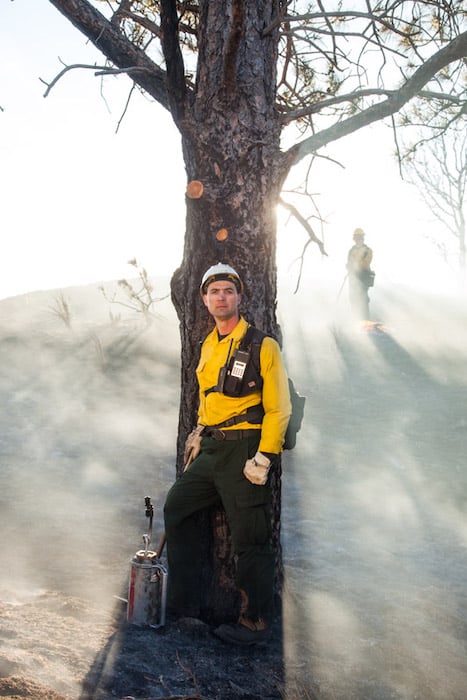Ryan Donnell's photograph of Jeremy Bailey post-fire standing against a tree