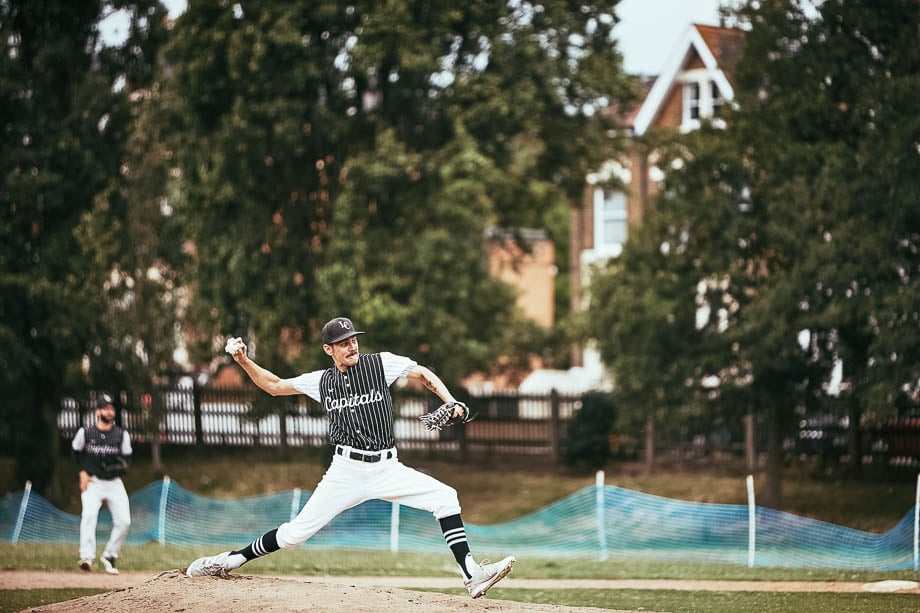 Photo of a baseball pitcher throwing a ball taken by London-based sports photographer Sam Todd. 