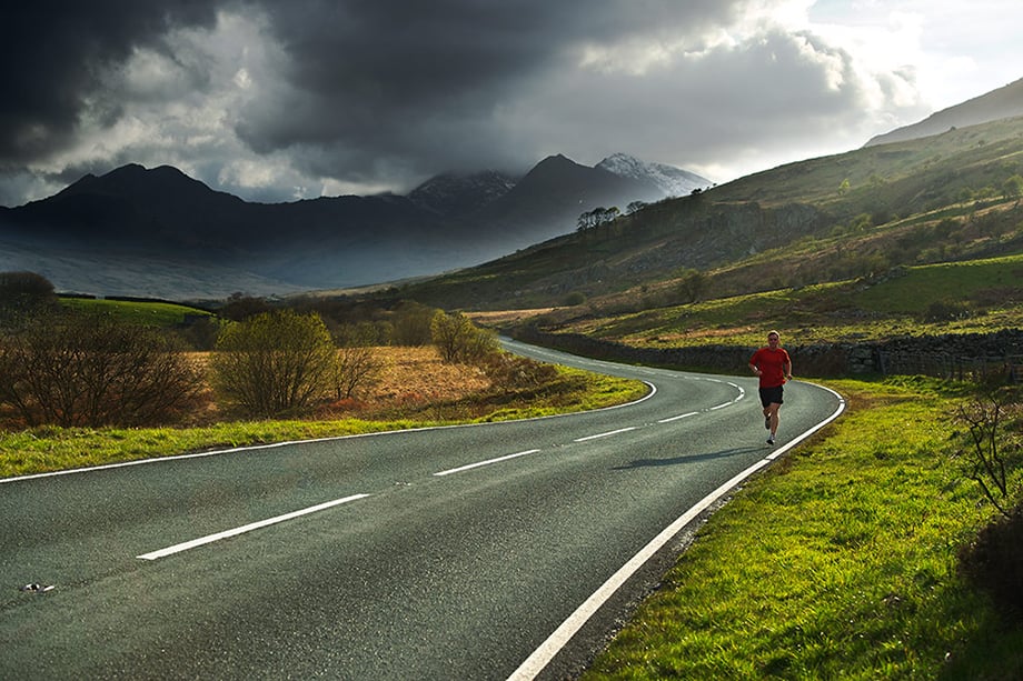 Photo of man running on a winding countryside road by UK-based photographer Ross Woodhall, for Dick's Sporting Goods.