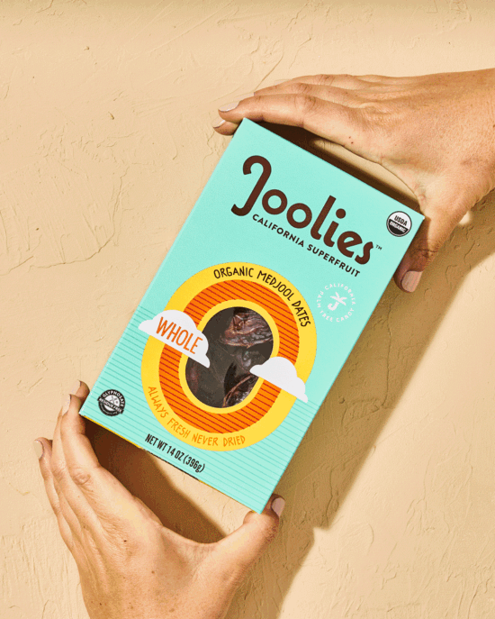 GIF of a hand opening a package of medjool dates and then depositing date pit, by Los Angeles product photographer Shelby Moore.