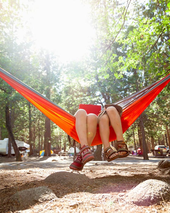 Photo of two people lying on a hammock at a camping site taken by Los Angeles-based lifestyle photographer Siri Berting.