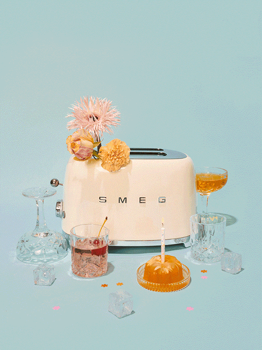 GIF of a SMEG toaster pushing out a piece of bread surrounded by sweets and drinks taken by Berlin-based product photographer Tabea Mathern. 