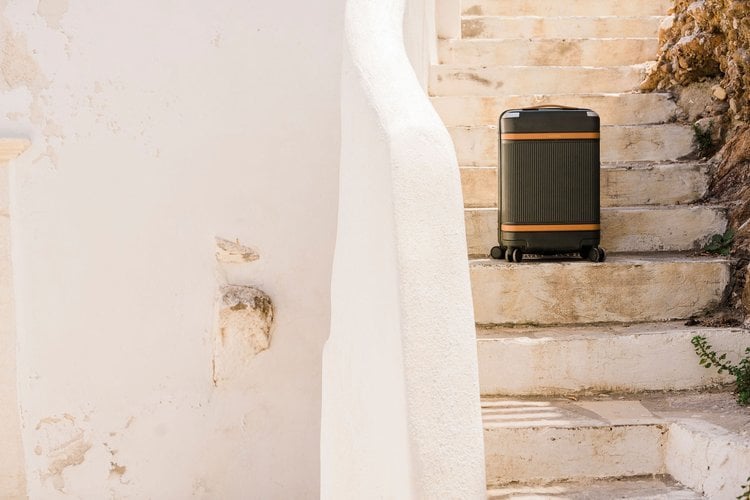 Portrait of hand luggage on white earthen staircase, by Los Angeles product photographer Teal Thomsen.