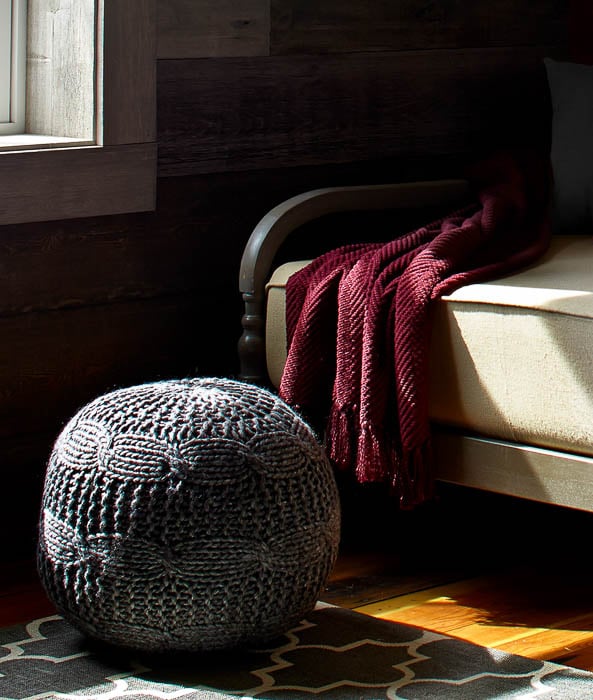 Photo of a dark red blanket and wool ball seat taken by San Francisco-based product photographer Ted Thomas of Zero Cool Studio. 