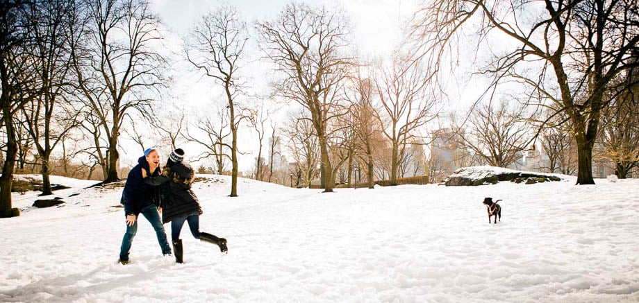 Photo of a couple and their dog having fun in the snow taken by Philadelphia-based lifestyle photographer Zave Smith. 