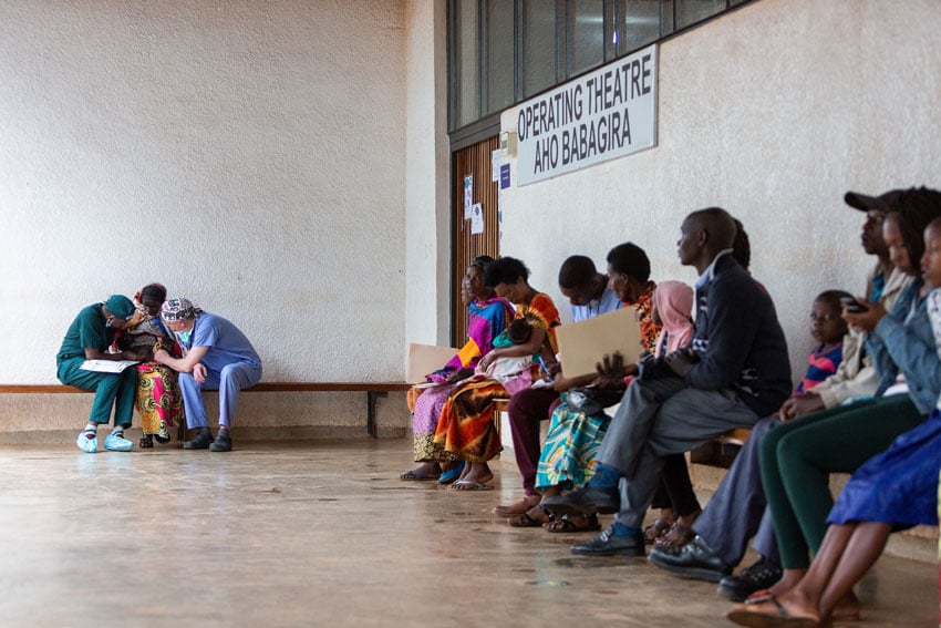 Zute Lightfoot photographs two doctors comforting a woman in a full waiting room for Operation Smile 