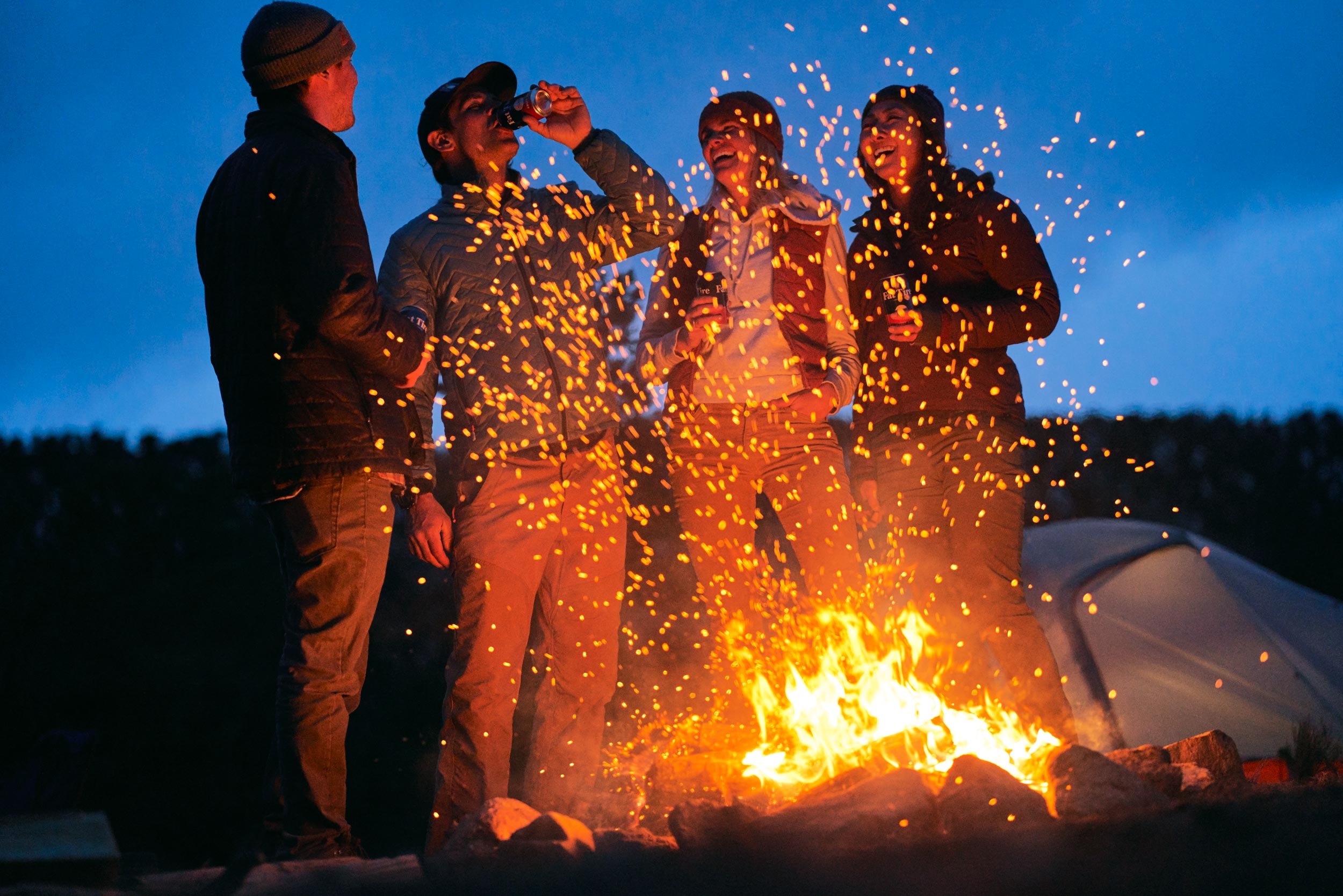 Andrew Maguire photographs friends around a campfire for a Fat Tire campaign in Colorado for New Belgium Brewing.