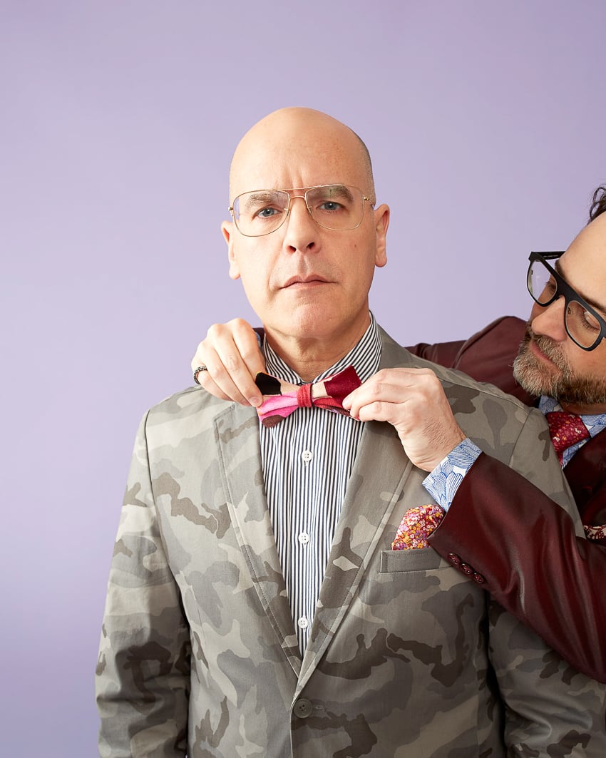 Photo by Stanton Stephens of a man fitting a bowtie on another man against a purple background for the Color is Everything Seattle Art Museum project.
