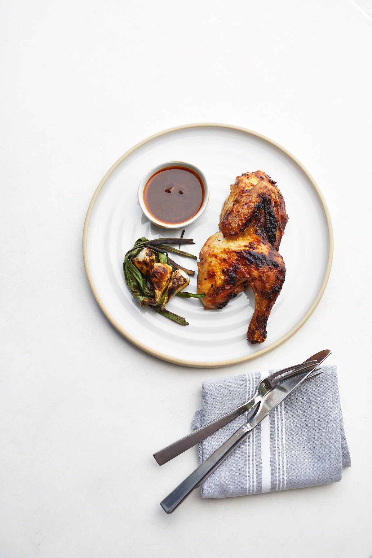 This shot by Jody Horton shows a simple plate of grilled chicken with sauce and grilled vegetables