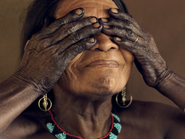 An Embera lady with her entire body painted black with jagua, shot by London-based photojournalist Piers Calvert