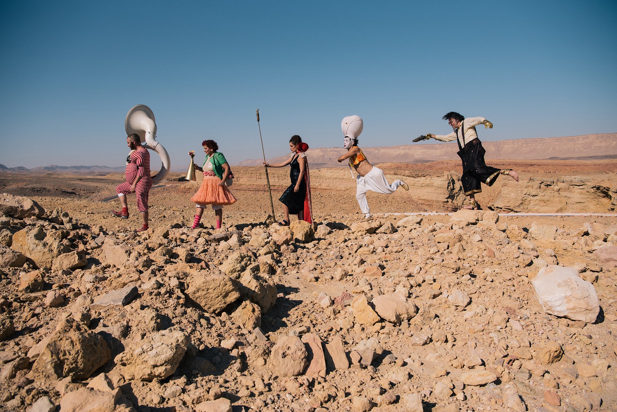 Arik Shraga photographs the epitome of a traveling circus with DAVAI Theater Group as they hop over sandy rocks in the desert