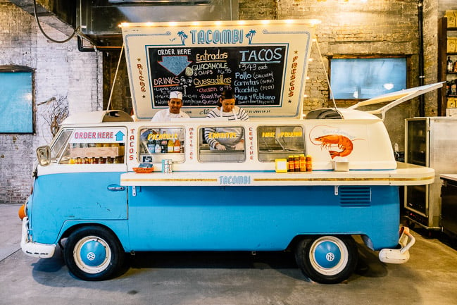 A photo of the Tacombi taco stand, which uses a 1970's VW as it's exterior.
