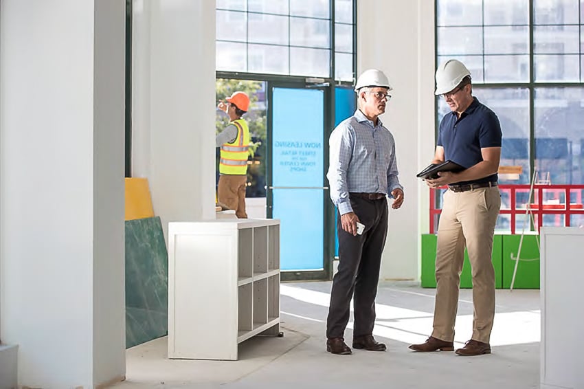 Image of of a Nationwide Insurance Agent and a small business owner in a commercial space under construction.