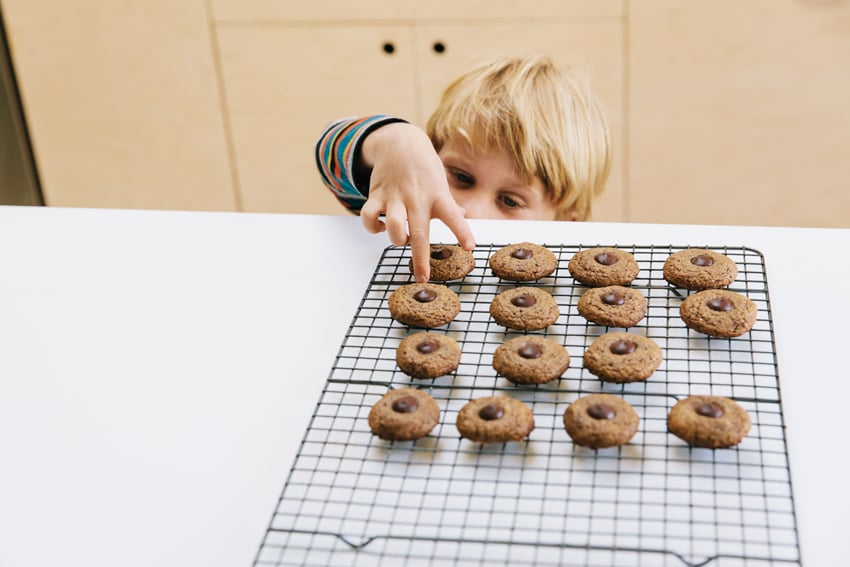 Child's small hands eagerly reach for a cookie. Photo by Elizabeth Cecil.