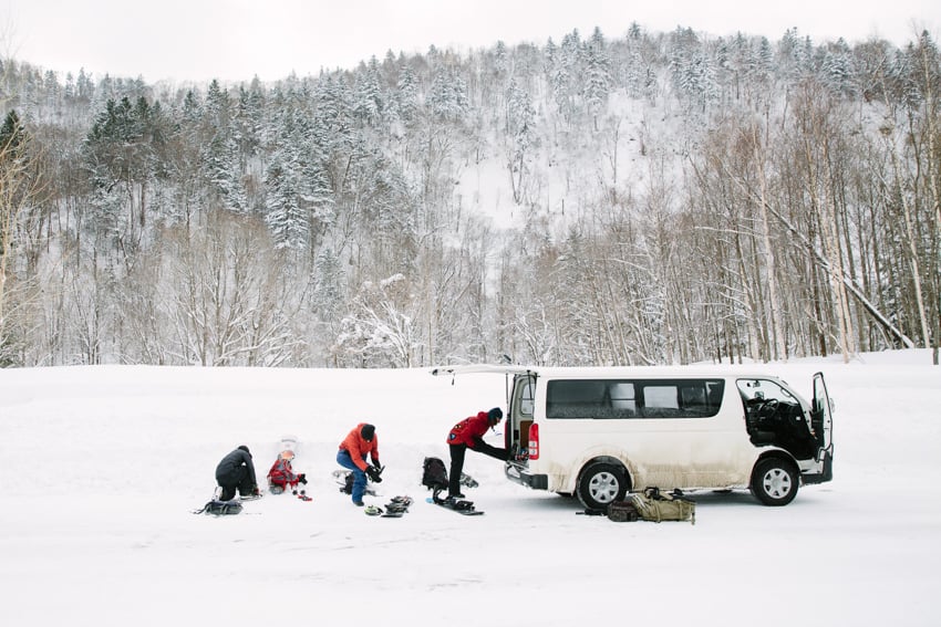 Snowboarders packing their equipment in a van photographed by Adam Moran.